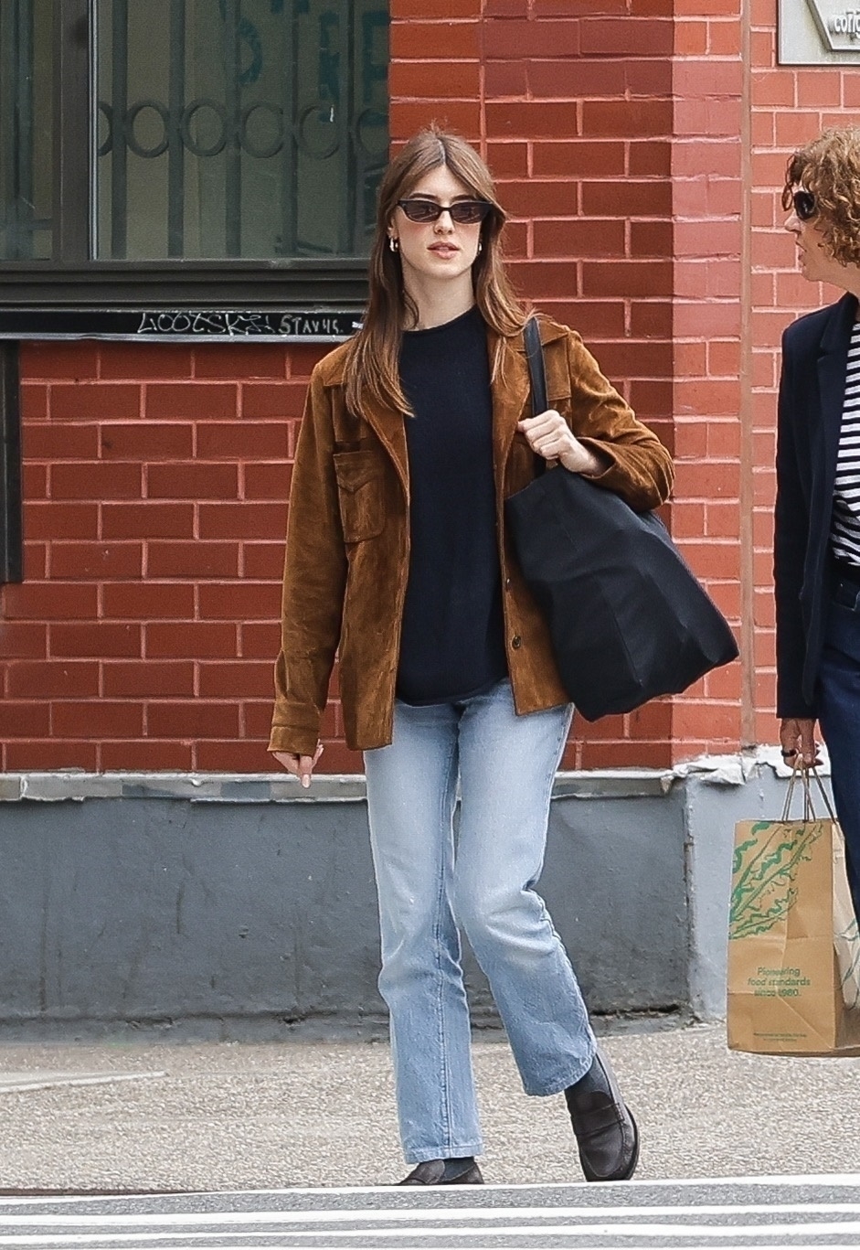 Daisy Edgar-Jones wearing a brown suede blazer, black sweater, vintage jeans, socks, and black loafers in SoHo.