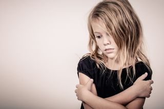 A little girl looks anxious