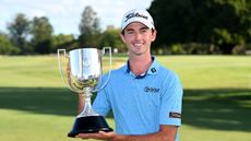 Elvis Smylie holds up the 2024 BMW Australian PGA Championship trophy