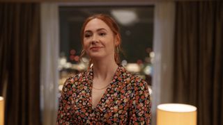 Karen Gillan in a brown floral dress as Madeline in Douglas is Cancelled episode 3