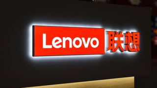 Red Lenovo logo sign with a white backlight, attached to a black backboard