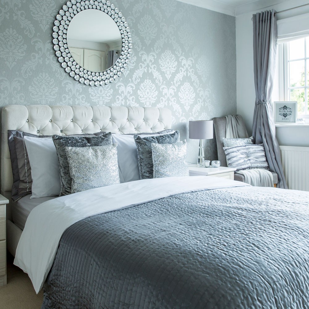 bedroom with grey bed and wallpaper