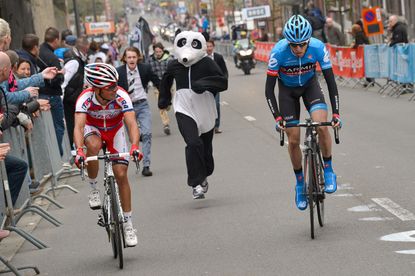 Dan Martin (right) is chased by a panda as he heads for victory at Liège-Bastogne-Liège in 2013