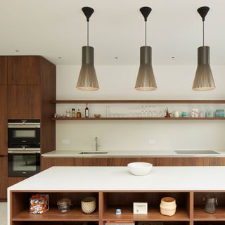 dark wood contemporary kitchen cabinetry with a kitchen island