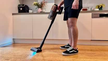Dreame Z20 vacuum cleaner being used in a kitchen.