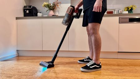 Dreame Z20 vacuum cleaner being used in a kitchen.