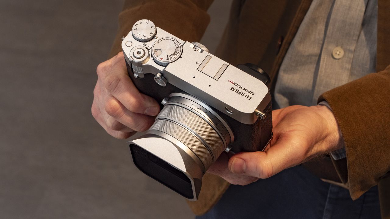 Holding the Fujifilm GFX100 RF medium-format compact camera