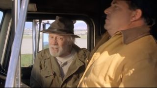 George Carlin wearing a hat and jacket catches a ride with a truck driver in Kevin Smith's 2001 comedy hit "Jay and Silent Bob Strike Back."