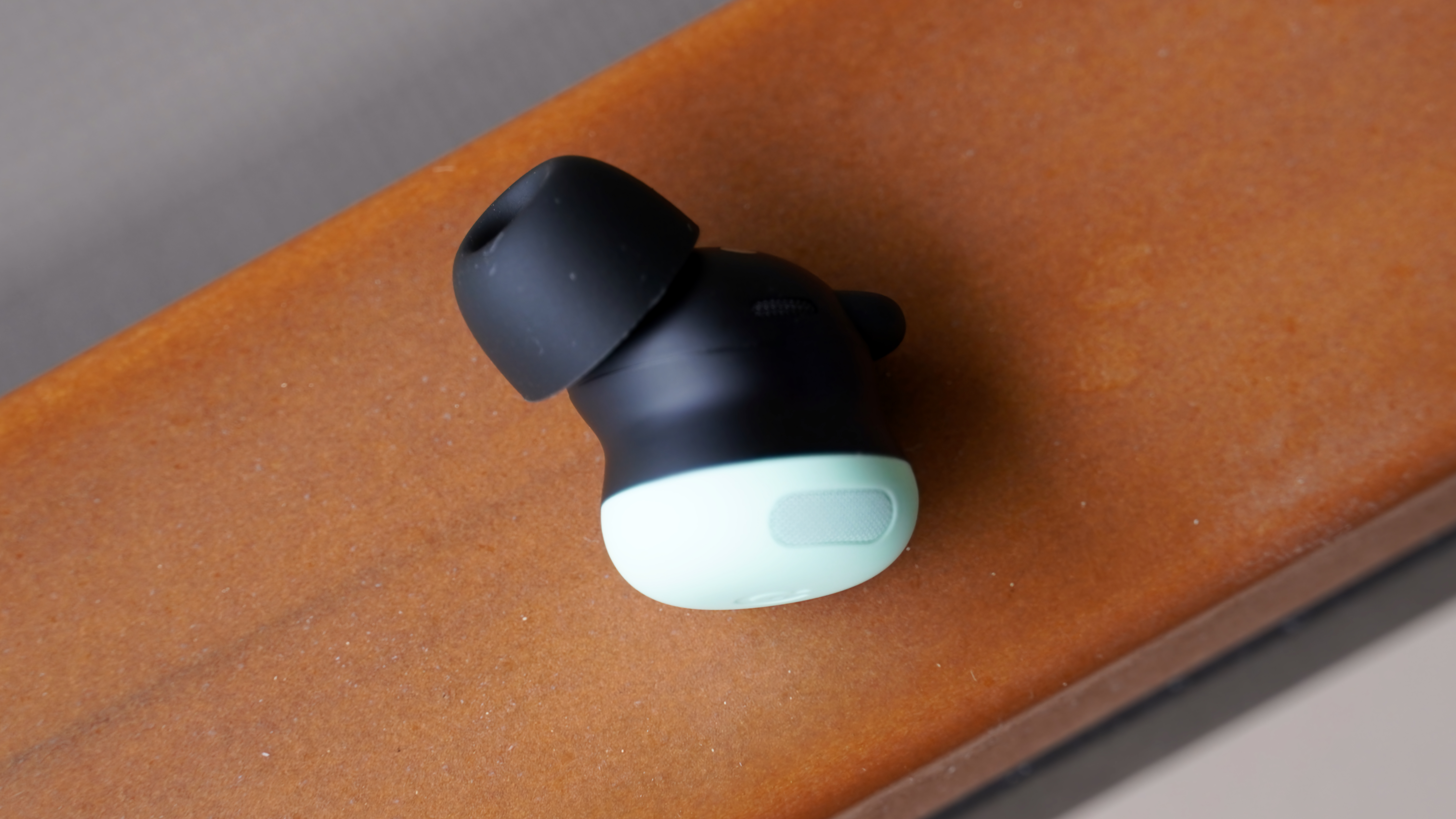 A single Google Pixel Buds Pro 2 earbud in the Mint colorway.