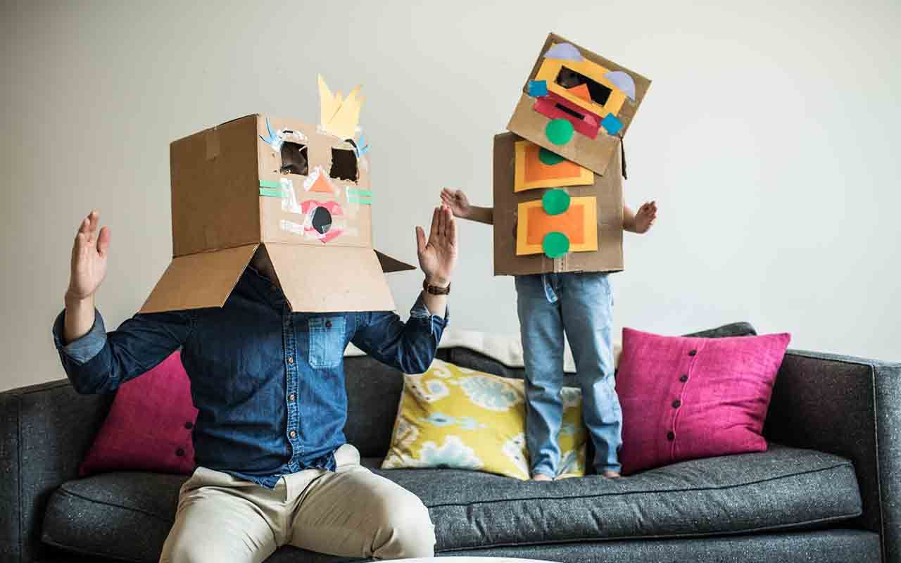 Father and daughter wearing robot costumes at home