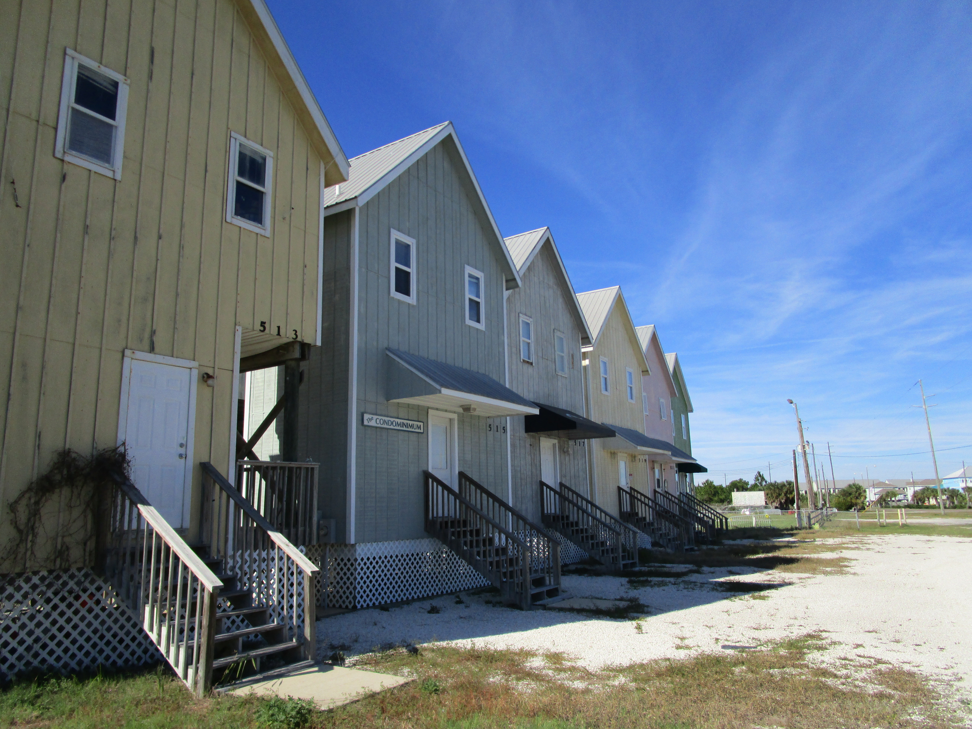 A row of very small beach houses along the main road that folks take to get onto Dauphin Island in Alabama.
