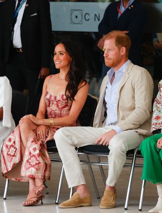 Meghan Markle wears a printed dress and brown strappy sandals in Bogota, Colombia.