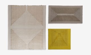 Three linen items. Left: A grey rectangular shaped item with a diamond pattern in the centre. Top right: A rectangular item in dark grey. Bottom right: a square item in gold with an internal square.