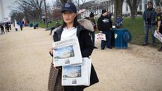 Woman passes out Epoch Times at "Stop the Steal" rally