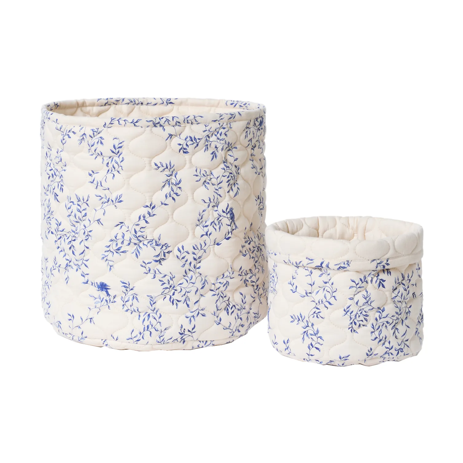 A set of two quilted white and blue storage baskets
