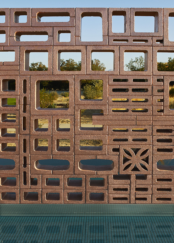Desert house by Robert Stone, a home made with perforated partitions and an intense pitched low roof