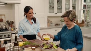 Meghan Markle in kitchen cooking with guest