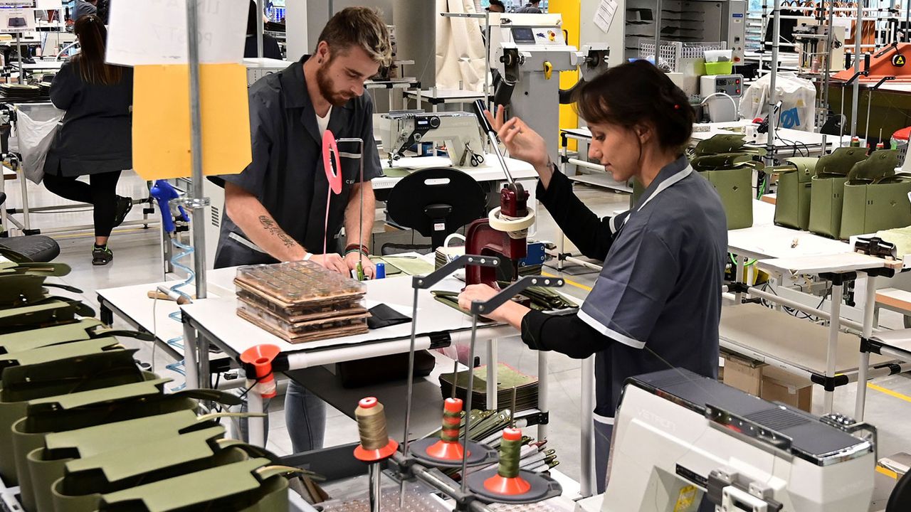 Workers at an LVMH handbag factory