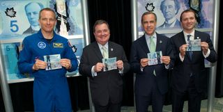 The Bank of Canada's new space-themed $5 note is a safer kind of dollar. From left to right: David Saint-Jacques, Canadian Astronaut; the Honourable Jim Flaherty, Minister of Finance; Mark Carney, Governor of the Bank of Canada; Paul G. Smith, Chairman of the Board of Directors of VIA Rail Canada.