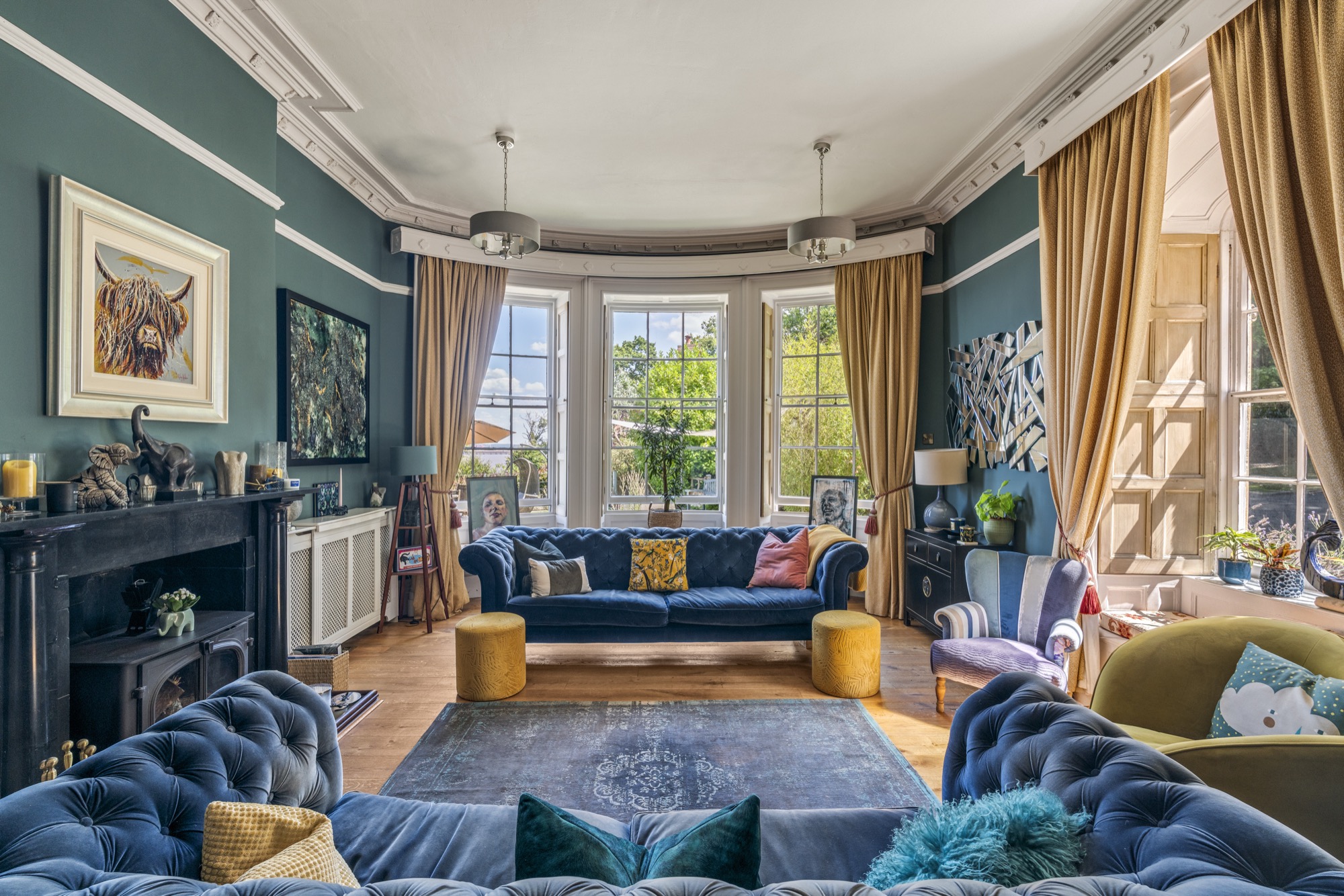 Detail of the interiors of Woodside, featuring lots of soft blues, funky artwork, wooden floors, and natural light
