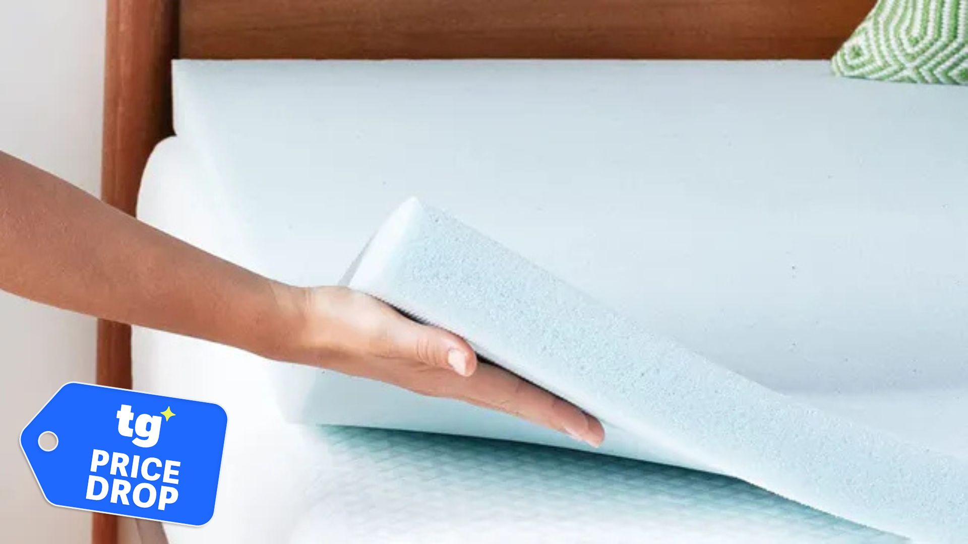 A hand lifts the Linenspa Gel Memory Foam Mattress Topper on a white mattress. A deal badge is located in the bottom left corner. 