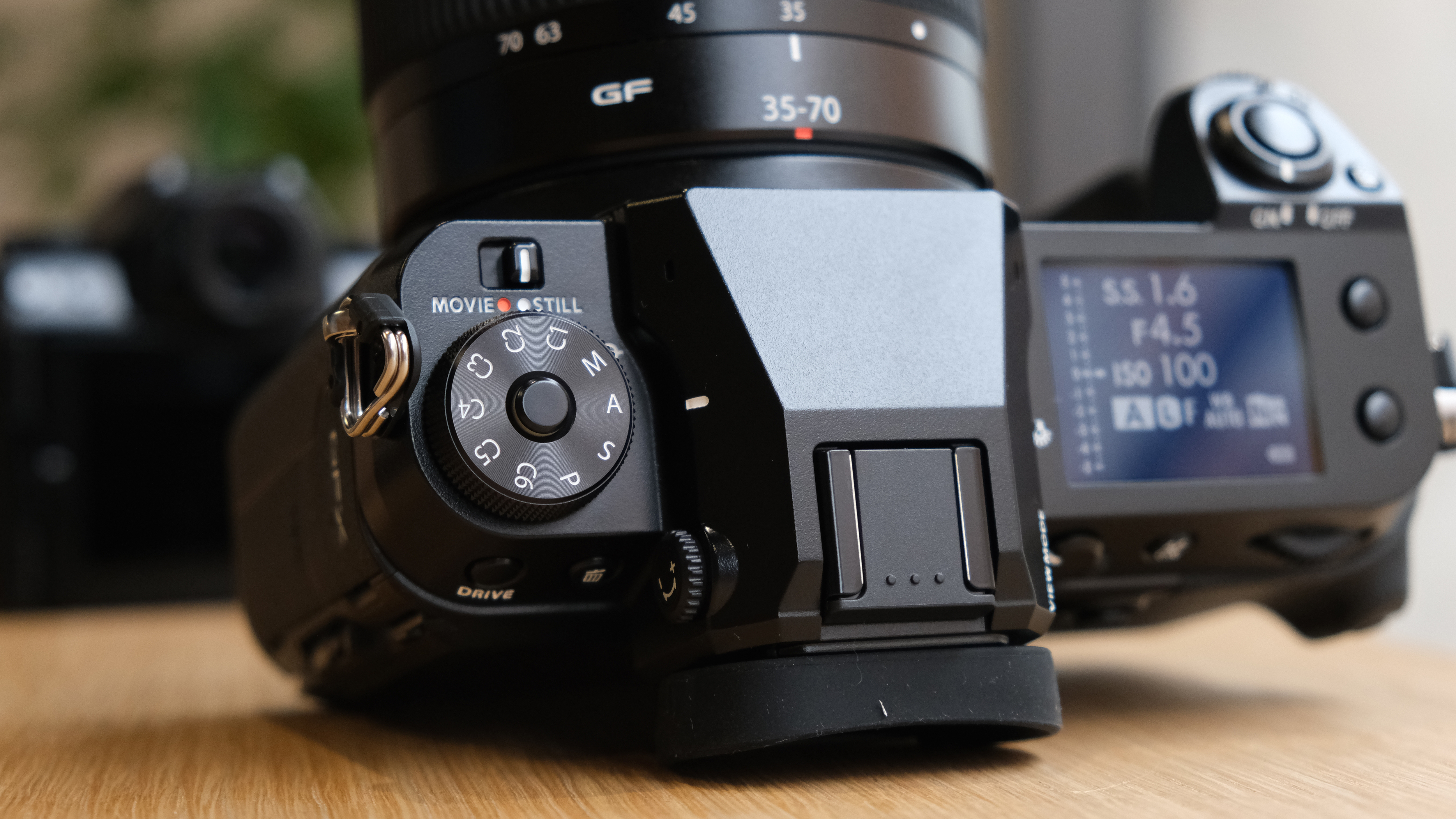 The Fujifilm GFX50S II on a wooden table