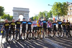 Team Sky standing in front of the Arc de Triomphe in Paris after Bradley Wiggins won the Tour de France in 2012 