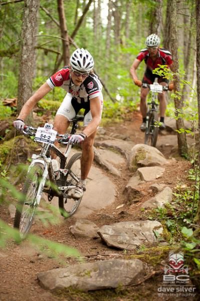 A Team Neilson rider negotiates some rocks.