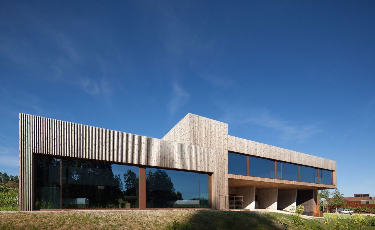 Exterior view of the Hotel Monverde. The modern-looking building was created out of granite and shale and clad with Portuguese pine, with large windows that are as high and wide as a room itself.