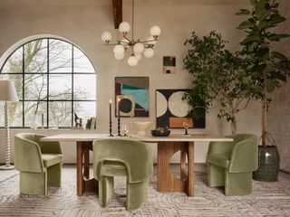 Living room with beige limewash walls, wooden dining table and olive green velvet chairs