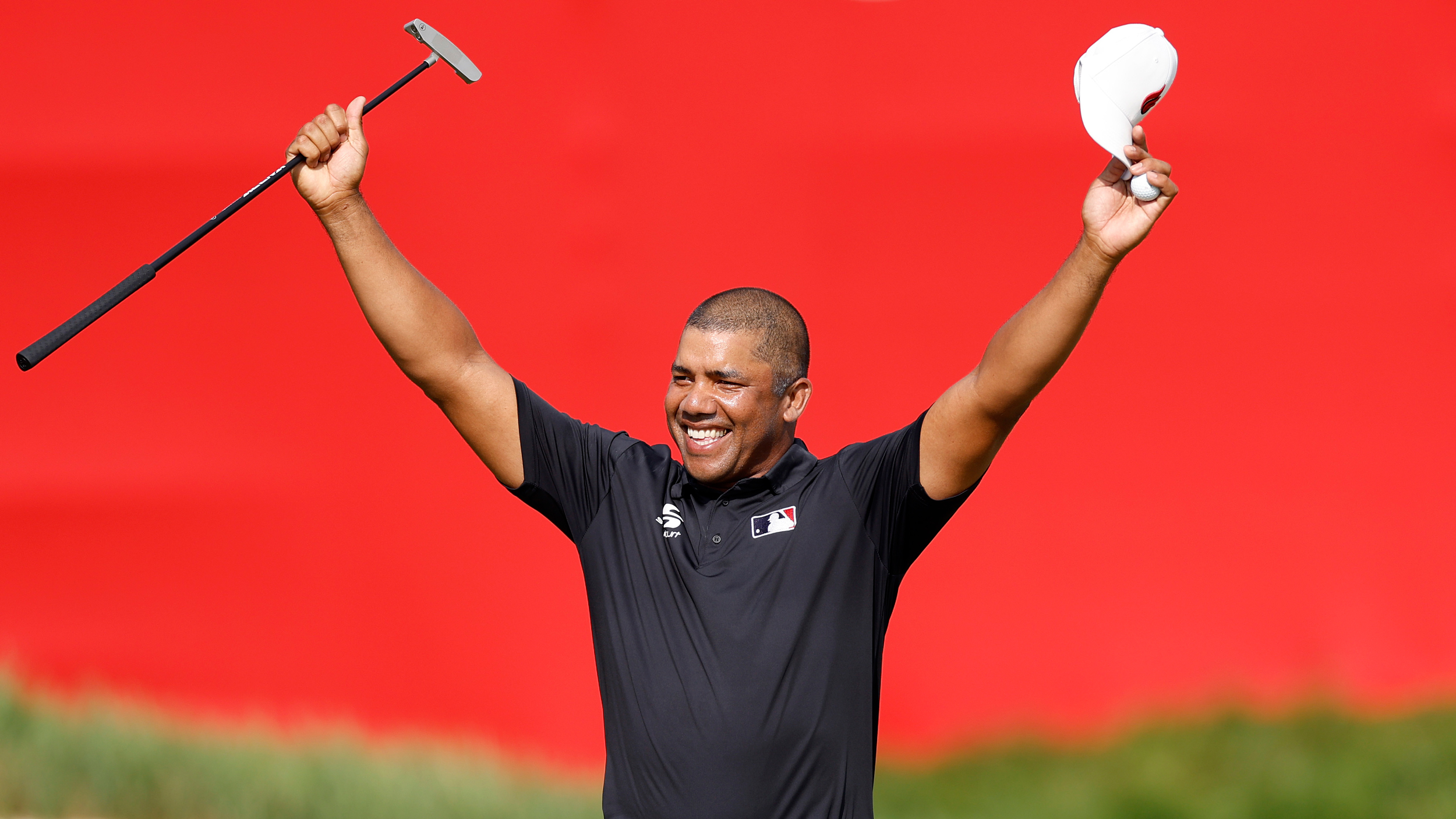 Jhonattan Vegas raises his arms in celebration at the 2024 3M Open while holding his putter and cap