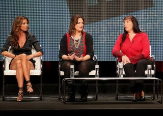 Teri, center, speaks onstage at a 2013 panel on domestic violence.