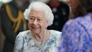 Queen Elizabeth II smiles during a visit to officially open the new building of Thames Hospice