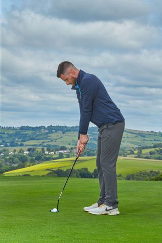 Barry Plummer preparing to hit a putt on the golf course