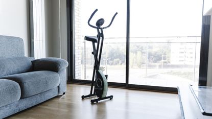 Best folding exercise bike: Pictured here, a folding exercise bike folded up in a living room