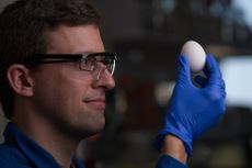 scientists holding egg