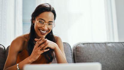 Woman in glasses looking at laptop