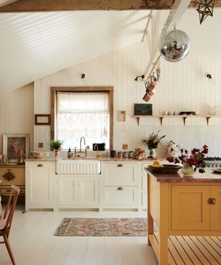 devol kitchens white shaker kitchen with statement yellow island and open shelving - boho styling