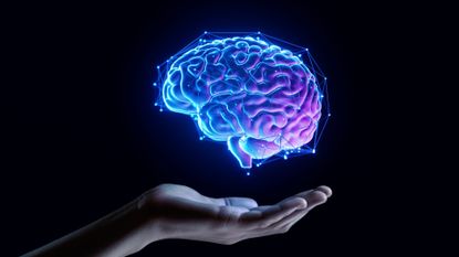 An illustration of a glowing brain overlaid with geometric lines floating over an outstretched hand