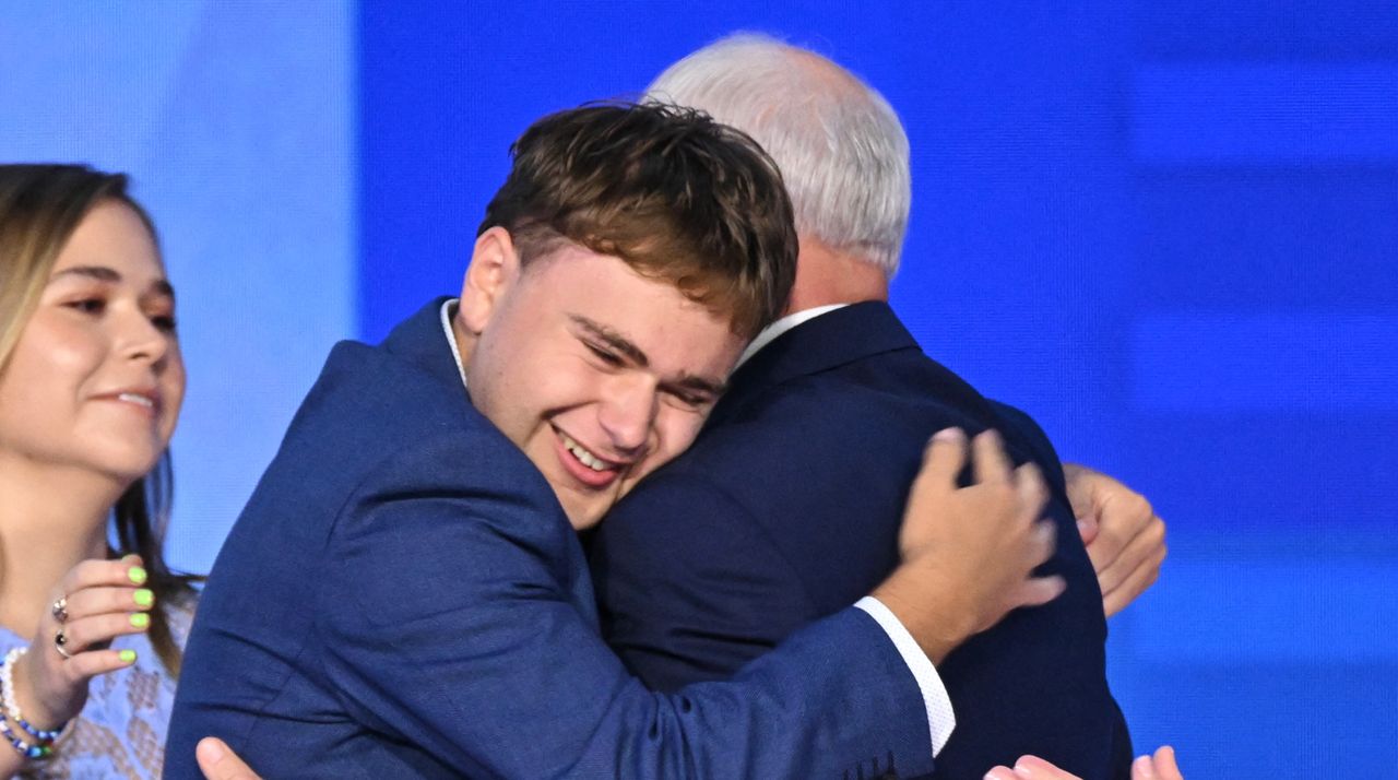 Minnesota Governor and Democratic vice presidential candidate Tim Walz is embraced by his son Gus. 