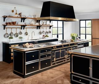 black kitchen with brass fixtures and fittings, two islands, marble countertops