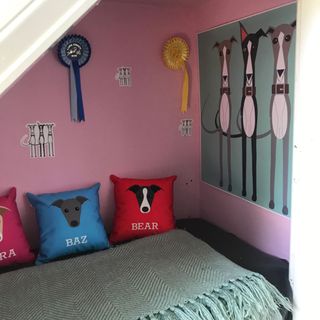 dog room with pink wall and cushions