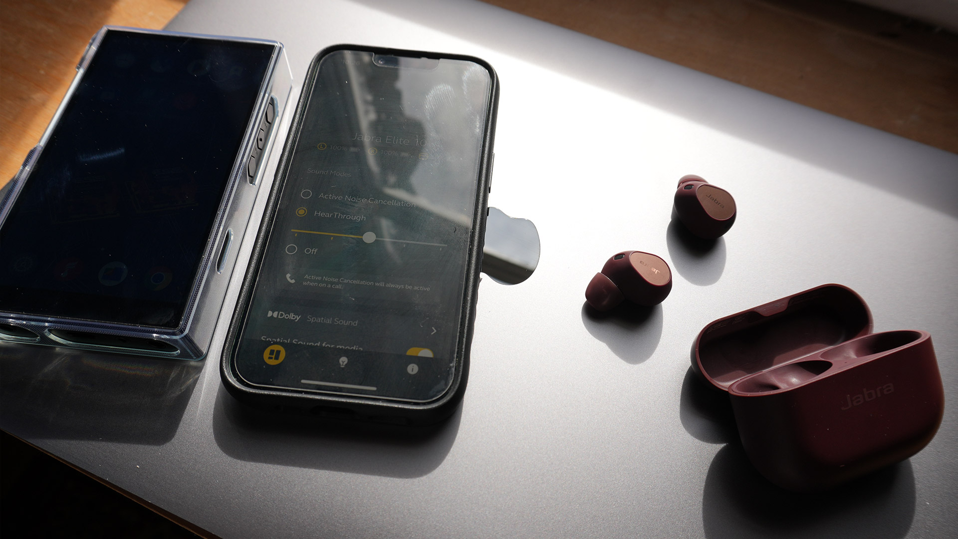 The Jabra Elite 10s on a Mac next to an iPhone and DAP