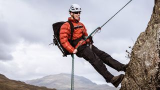 A man rappelling in the Lake District, UK
