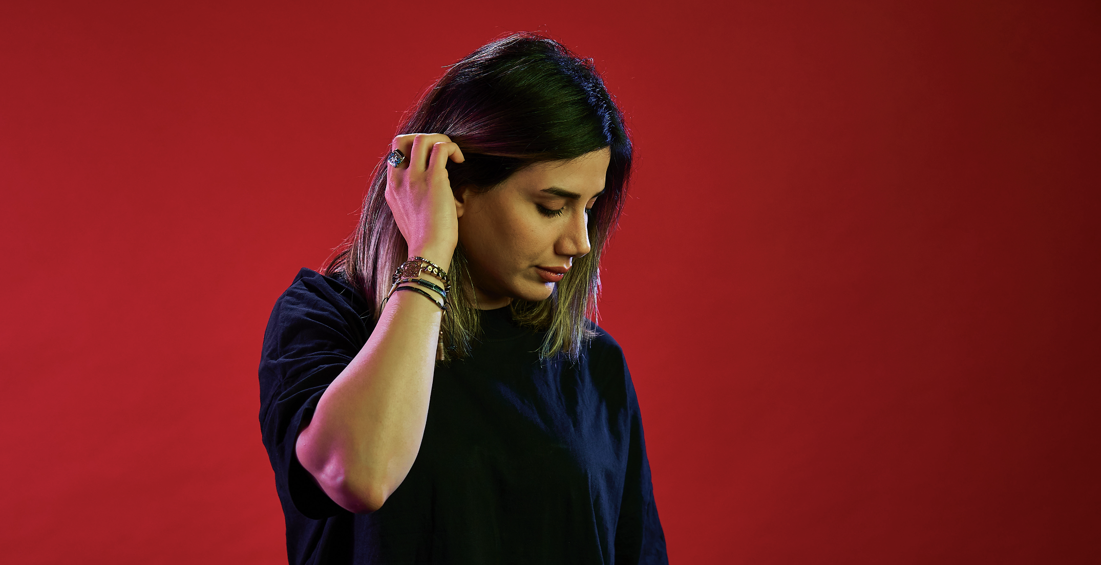 woman looking to the side on a red background