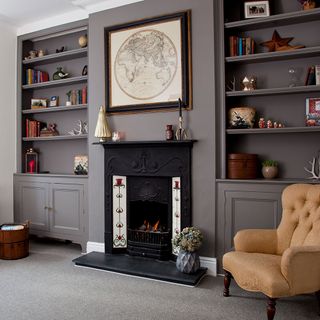 grey living room with carpet flooring and armchair