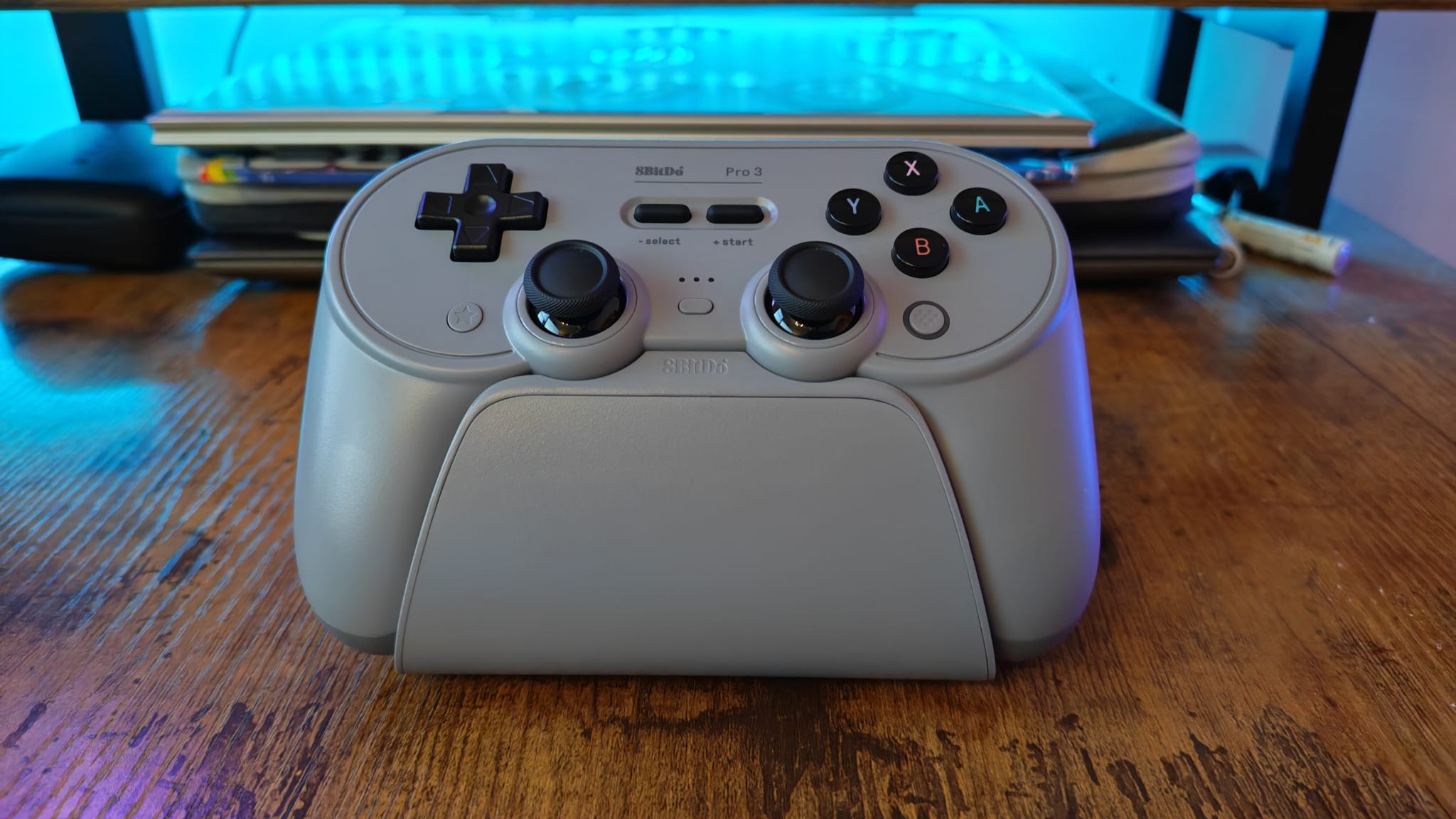 An 8BitDo Pro 3 controller on its charging stand