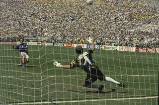 Italy's Franco Baresi fires his penalty over the crossbar as Brazil's Taffarel dives to his left in the shootout to decide the winner of the 1994 World Cup.