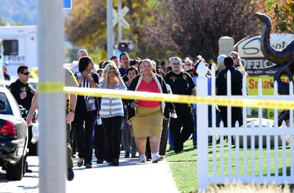 Police escort civilians away from the 1300 block of S. Waterman Street near the site of a shooting took place on December 2, 2015 in San Bernardino, California. 