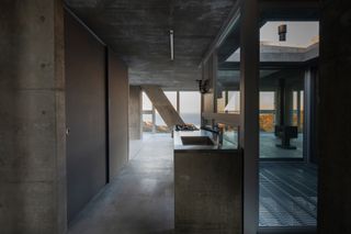 The concrete and glass kitchen at Torus House by Noriaki Hanaoka Architecture